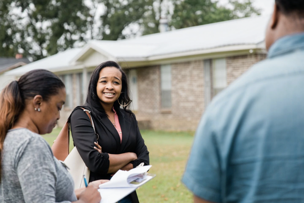 Realtor Mishaè Dickerson, left, shows a home to Astardii and Rick Hopkins in Birmingham, Ala., last month. The couple say their college loan debt limited their options. (Cameron Carnes/For The Washington Post)