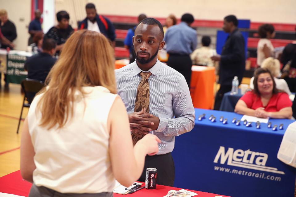 Job seekers attend a career fair. Many of the challenges black households face have to do with not benefiting from job and wage growth.