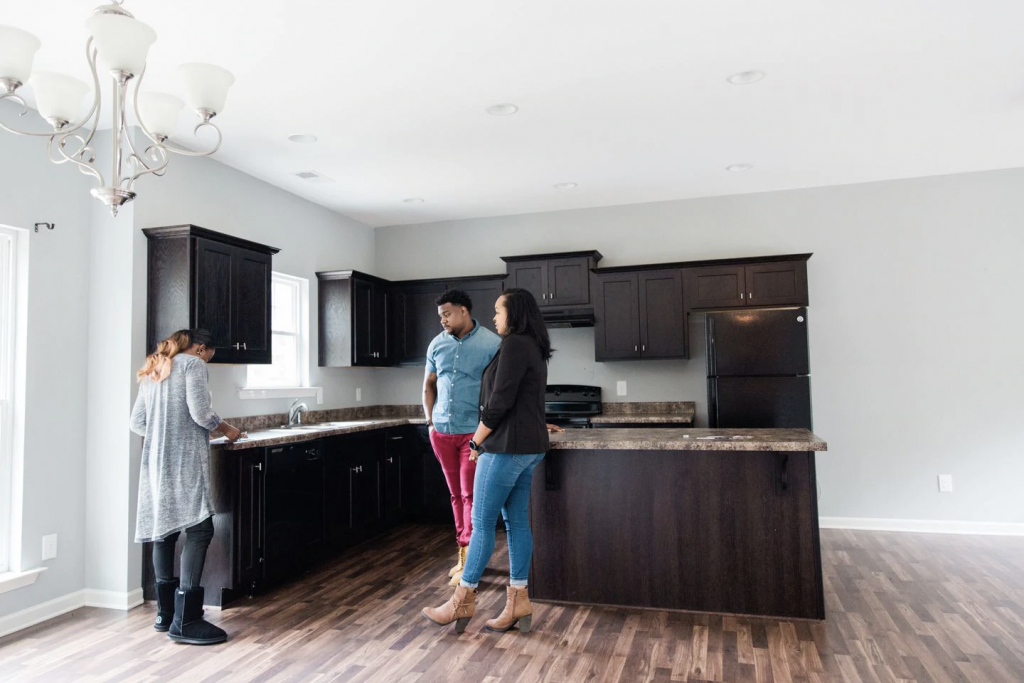 Mishaè Dickerson and Astardii and Rick Hopkins look at a kitchen. (Cameron Carnes/For The Washington Post)